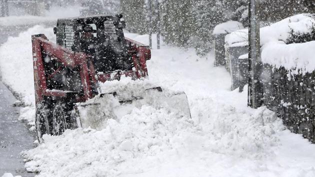 Persistent snow and freezing conditions caused delays in many parts of Britain, with roads and train service hit particularly hard. Emergency officials said many drivers had to be rescued from stranded vehicles. (Niall Carson / AP)