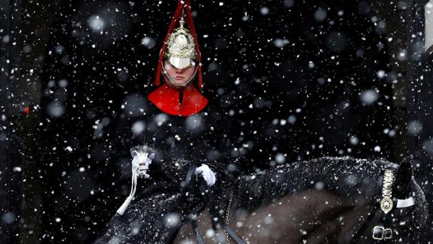 A guardsman sits on duty in the snow at Horse Guards Parade in London. (Peter Nicholls / REUTERS)