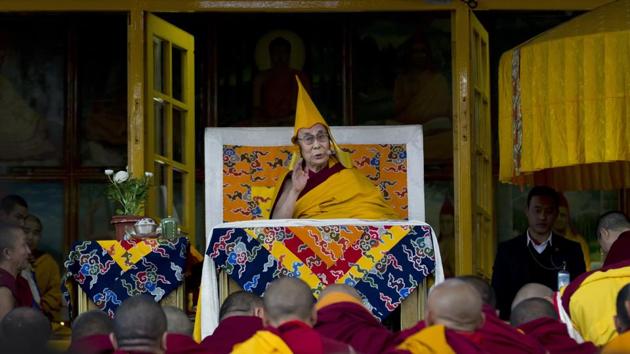 Tibetan spiritual leader the Dalai Lama wears the ceremonial hat of the Gelug school of the Tibetan Buddhism as he gives a religious talk at the Tsuglakhang temple in Dharmsala, India on Friday. (Ashwini Bhatia) / AP) Tibetan spiritual leader the Dalai Lama wears the ceremonial hat of the Gelug school of the Tibetan Buddhism as he gives a religious talk at the Tsuglakhang temple in Dharmsala, India on Friday. (Ashwini Bhatia) / AP)