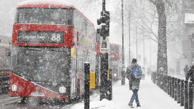 A man walks during a blizzard in central London as temperatures remain below freezing point. The weather in Britain and northwestern Europe is to some extent a mirror image of the “sudden stratospheric warming” in the arctic, experts say, referring to a disturbance in the polar jet stream that has alarmed scientists. (Tolga Akmen / AFP)