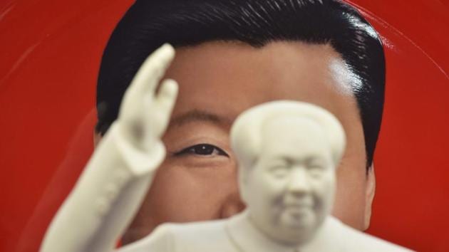 A decorative plate featuring an image of Chinese President Xi Jinping is seen behind a statue of Mao Zedong at a souvenir store next to Tiananmen Square in Beijing. The country has shocked many observers by proposing a constitutional amendment to end the two-term limit for presidents, giving Xi a clear path to rule the world's second largest economy for life. (Greg Baker / AFP) 
