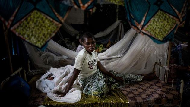 An Internally Displaced Congolese woman rests with her new born child in a clinic for IDP's just out side the camp in Bunia. Twenty-three people were killed in renewed clashes between ethnic groups in the Democratic Republic of Congo's troubled east. (John Wessels / AFP) 
