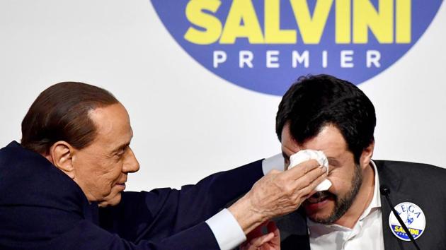 Silvio Berlusconi (L) wipes the forehead of the League’s Matteo Salvini, as he jokes with him during a press conference with Brothers of Italy (unseen) at the in Rome. Berlusconi's rightwing coalition, on course to win the most votes in Italy's election, held its first and last public meeting on March 1 in an attempt to quell speculation of severe internal divisions. (Alberto Pizzoli / AFP) 