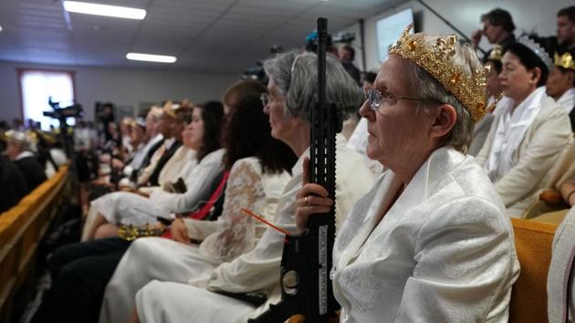 Hundreds of worshipers gathered inside World Peace and Unification Sanctuary in Pennsylvania at a blessing ceremony for couples featuring their AR-15 rifles which they claim symbolize the "rod of iron" in the biblical book of Revelation. (Don Emmert / AFP) 
