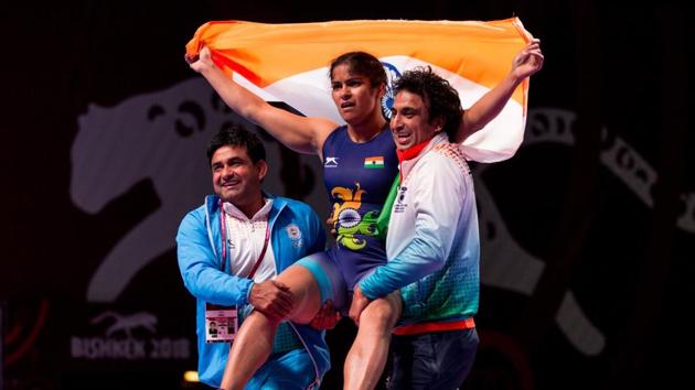 Navjot Kaur celebrates with coaches after winning gold in the Asian Wrestling Championships in Bishkek, Kyrgyzstan, on Friday.(HT Photo)