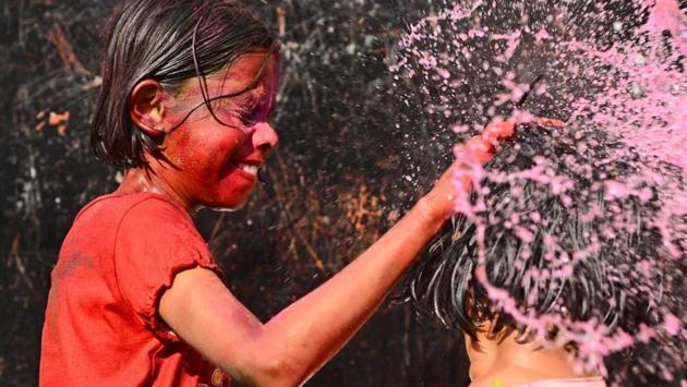 Children play with colour and water during Holi celebrations in the city on Friday. (shankar narayan/ht photo) Children play with colour and water during Holi celebrations in the city on Friday. (shankar narayan/ht photo)