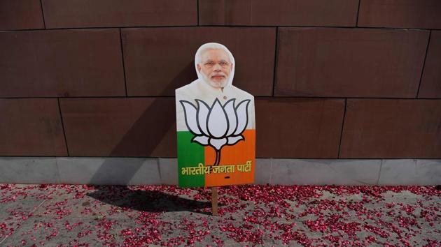 A placard with the image of Prime Minister Narendra Modi is pictured near a rally of supporters of the Bharatiya Janata Party (BJP) as they celebrate following state election victories, outside the BJP headquarters in New Delhi on March 3. (AFP Photo) A placard with the image of Prime Minister Narendra Modi is pictured near a rally of supporters of the Bharatiya Janata Party (BJP) as they celebrate following state election victories, outside the BJP headquarters in New Delhi on March 3. (AFP Photo)