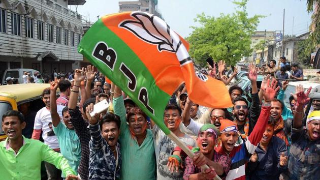 BJP supporters wave party flag to celebrate BJP's lead in Tripura assembly elections, in Agartala. (PTI Photo) BJP supporters wave party flag to celebrate BJP's lead in Tripura assembly elections, in Agartala. (PTI Photo)