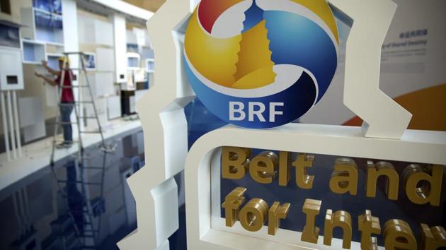 A worker disassembles a photo display for the Belt and Road Forum at the China National Convention Center in Beijing. (AP File Photo) A worker disassembles a photo display for the Belt and Road Forum at the China National Convention Center in Beijing. (AP File Photo)