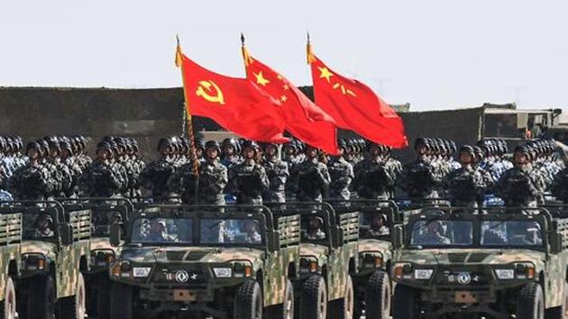 This file picture taken on July 30, 2017 shows Chinese soldiers carrying the flags of (L to R) the Communist Party, the state, and the People's Liberation Army during a military parade at the Zhurihe training base in China. (AFP File Photo) This file picture taken on July 30, 2017 shows Chinese soldiers carrying the flags of (L to R) the Communist Party, the state, and the People's Liberation Army during a military parade at the Zhurihe training base in China. (AFP File Photo)