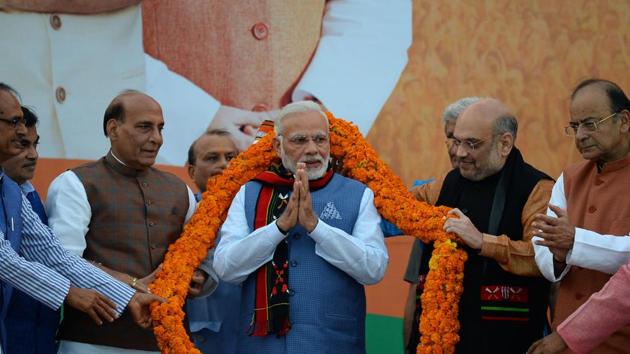 Prime Minister Narendra Modi gestures as he is garlanded by BJP leaders during the election results of three northeast states at the BJP headquarters in New Delhi on March 3. (AFP Photo) Prime Minister Narendra Modi gestures as he is garlanded by BJP leaders during the election results of three northeast states at the BJP headquarters in New Delhi on March 3. (AFP Photo)