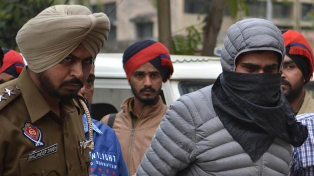 Gangster Tirath Singh in Jalandhar police custody on Saturday. (Pardeep Pandit/HT) Gangster Tirath Singh in Jalandhar police custody on Saturday. (Pardeep Pandit/HT)