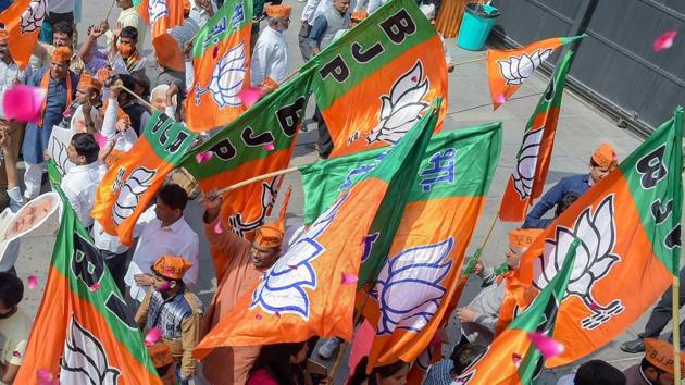 BJP party workers celebrate at party headquarters after assembly election results, in New Delhi.(PTI Photo)