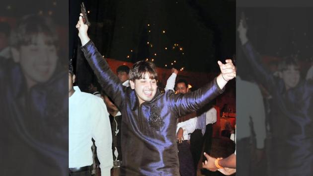 Akash Yadav dancing with a gun in his hand at the wedding of his brother in 2013 in Gurgaon.(Parveen Kumar/HT Photo)
