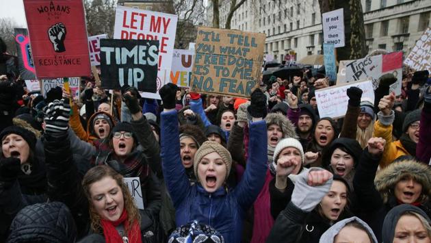 Protesters hold up placards during the Women's March in London on January 21. Hundreds of people gathered outside Downing Street in London to voice their frustration at sexual harassment, violence and discrimination against women(AFP)