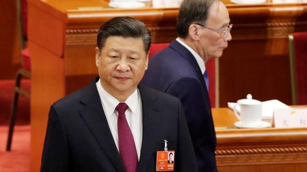 Wang Qishan, former secretary of the Central Commission for Discipline Inspection, walks past Chinese President Xi Jinping at the opening session of the National People's Congress (NPC) at the Great Hall of the People in Beijing. (REUTERS) Wang Qishan, former secretary of the Central Commission for Discipline Inspection, walks past Chinese President Xi Jinping at the opening session of the National People's Congress (NPC) at the Great Hall of the People in Beijing. (REUTERS)