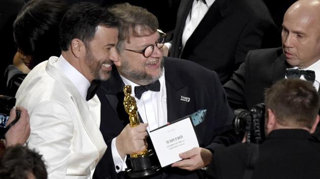 Guillermo del Toro (R), winner of the award for best picture for "The Shape of Water" celebrates with host, Jimmy Kimmel at the Oscars. Guillermo del Toro’s lavish, romantic monster fable “The Shape of Water” swam away with best picture at an Oscar ceremony flooded by a sense of a change for a movie business confronting the post-Harvey Weinstein era. (Chris Pizzello/Invision/AP)