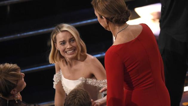 Margot Robbie (L) reacts as Allison Janney wins the award for best performance by an actress in a supporting role for "I, Tonya" at the Oscars on Sunday. (Chris Pizzello / Invision / AP)