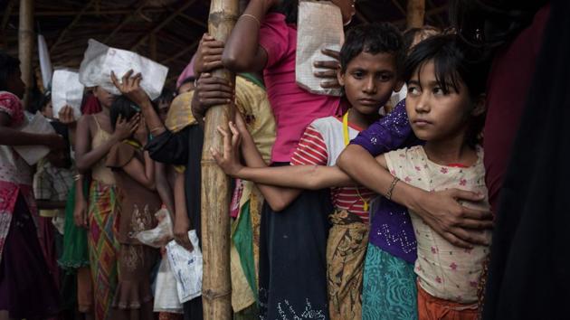Rohingya migrants wait at a relief centre at the Balukhali refugee camp at Cox's Bazar in Bangladesh on November 30, 2017. Rohingya are still fleeing into Bangladesh even after an agreement was signed with Myanmar to repatriate hundreds of thousands of the Muslim minority displaced along the border. (AFP) Rohingya migrants wait at a relief centre at the Balukhali refugee camp at Cox's Bazar in Bangladesh on November 30, 2017. Rohingya are still fleeing into Bangladesh even after an agreement was signed with Myanmar to repatriate hundreds of thousands of the Muslim minority displaced along the border. (AFP)
