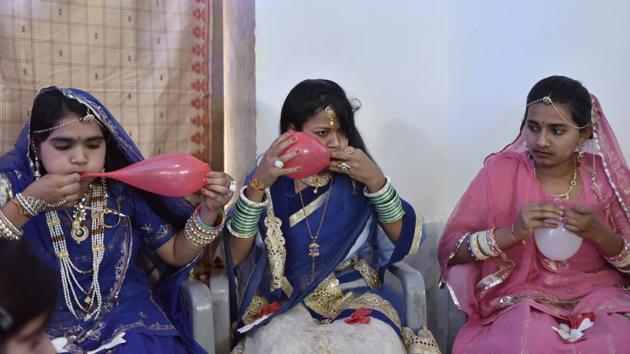 Pictured in the centre, Shobha inflates a balloon during the farewell party of students of the 12th grade at the Veerni Institute. Dressed in traditional Rajasthani wear, the girls were also part of a dance competition. “Many former students are now teachers. One has set up a yoga centre,” says Mahendra Sharma, director of Veerni Institute. (Anushree Fadnavis / HT Photo) 
