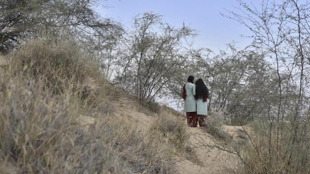 Two child brides are pictured a little further into the sand dunes close to the Veerni Institute. Radha, one of the child brides, says she wants to become an IPS officer “so that I can stop child marriages from occurring and ensure that girls study further.” Suman, 16, who is now in Class 11, wants to be a teacher or police officer. (Anushree Fadnavis / HT Photo) 