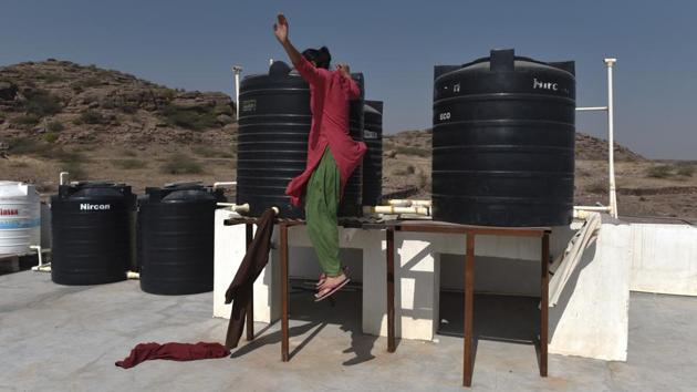 Life is disciplined and structured around the school day, at the single- storey institute—which also has a computer lab, sewing room and a playground with see-saw and roundabout.  On the terrace, however, is a casual affair. Girls often come out here to dry clothes, sometimes just gaze at the landscape outside as well as jump off the water tank stand for fun, as seen here. (Anushree Fadnavis / HT Photo) 