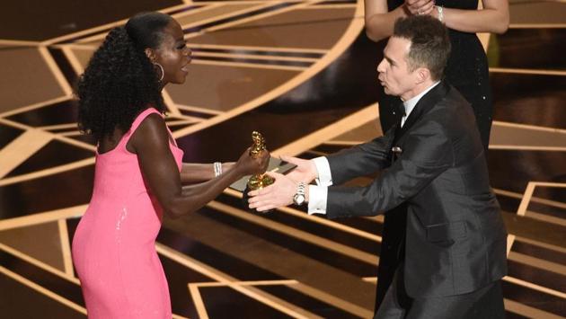 Viola Davis, left, presents Sam Rockwell with the award for best performance by an actor in a supporting role for "Three Billboards Outside Ebbing, Missouri" at the Oscars. The actor dedicated his award to legendary veteran actor Philip Seymour Hoffman and gave a shout-out to him by saying, “This is for my old buddy, Phil Hoffman.” (Chris Pizzello / Invision / AP)