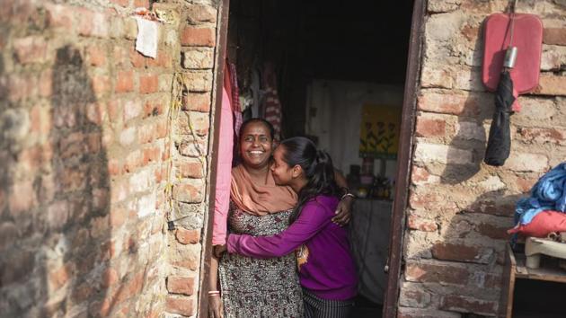Binota shares a moment with her daughter Kritika, at their home in Govindpuri. Between her to and fro journeys from Govindpuri metro station to Tara Apartments, she makes time to pick and drop her daughter from school. “My daughter is proud that I am doing something different,” she says. (Burhaan Kinu / HT Photo) 
