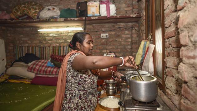 Binota prepares a meal, at her one-bedroom home. “Since my childhood I had been working as a maid or a cook across cities like Mumbai, Kolkata, before settling here in Delhi. I used to travel then from one house to another on a bicycle,” she said, pointing that the money from that line of work wasn’t enough. (Burhaan Kinu / HT Photo) 
