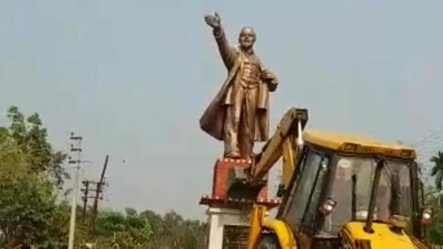 Statue of Lenin being demolished at Belonia town in South Tripura on Monday with the help of a bulldozer.(HT Photo)