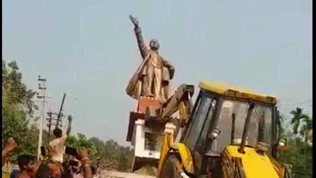 Statue of Lenin being demolished at Belonia town in South Tripura on Monday with the help of a bulldozer.(HT photo)