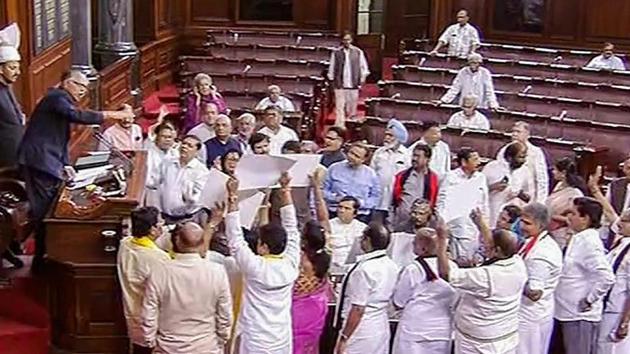 Opposition members protest in the well of the Rajya Sabha in New Delhi on Tuesday. (PTI Photo) Opposition members protest in the well of the Rajya Sabha in New Delhi on Tuesday. (PTI Photo)