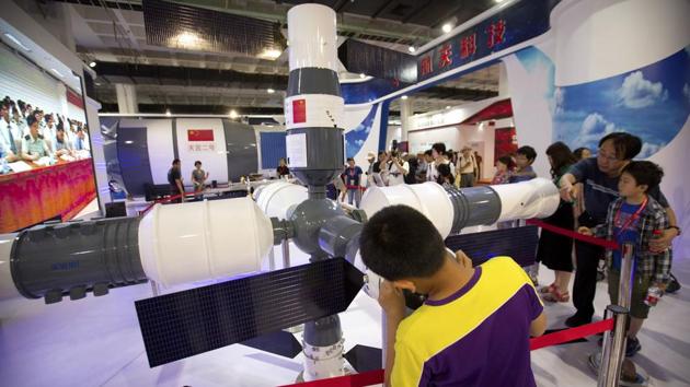 Visitors look at a model of China's Tiangong-1 space station at the China Beijing International High-Tech Expo in Beijing, June 10, 2017. (AP File Photo) Visitors look at a model of China's Tiangong-1 space station at the China Beijing International High-Tech Expo in Beijing, June 10, 2017. (AP File Photo)
