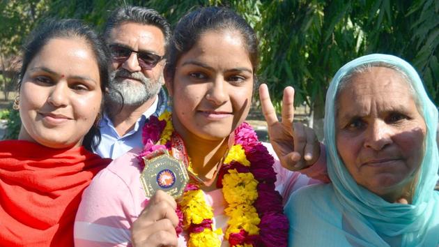 Wrestler Navjot Kaur with her mother showing her medal at the international airport in Amritsar on Monday. (Sameer Sehgal/HT) Wrestler Navjot Kaur with her mother showing her medal at the international airport in Amritsar on Monday. (Sameer Sehgal/HT)