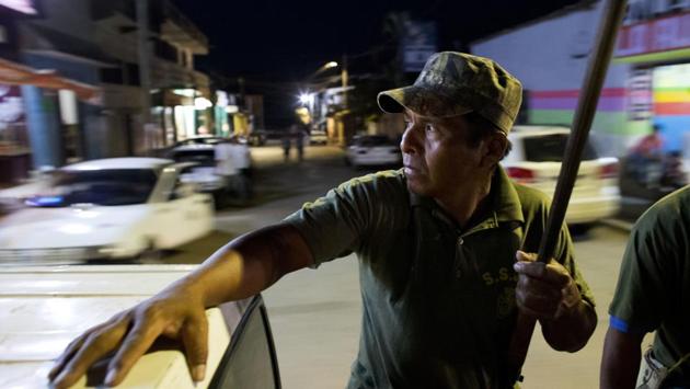 A “community police” vigilante, Rene Zeferino rides in the back of a truck as his unit patrols the streets of Ayutla de los Libres, Guerrero state, Mexico. Fed up with police corruption and drug gang violence, a number of communities in this southern Mexico state and neighboring areas have formed citizen police groups. The state saw 2,318 homicides last year as criminal gangs battled for territory or killed to intimidate victims. (Rebecca Blackwell / AP)