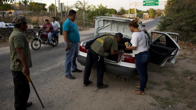 For these citizen cops, being on duty can mean manning an impromptu roadblock to search vehicles for contraband, monitoring bars for nefarious activities or watching over rudimentary police stations complete with jail cells. (Rebecca Blackwell / AP)