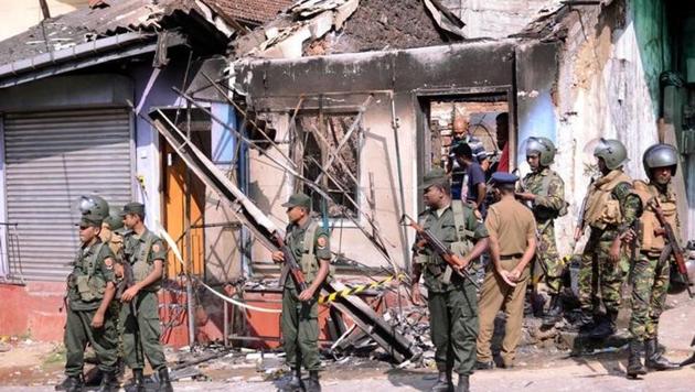 Sri Lanka's Special Task Force stand guard near a burnt house after a clash between two communities in Digana, central district of Kandy, on Tuesday. (Reuters photo) Sri Lanka's Special Task Force stand guard near a burnt house after a clash between two communities in Digana, central district of Kandy, on Tuesday. (Reuters photo)