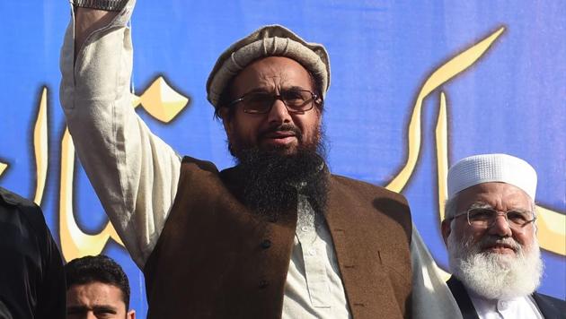 Pakistani head of the Jamaat-ud-Dawa (JuD) terror group Hafiz Saeed waves during a rally in Lahore.(AFP File Photo)