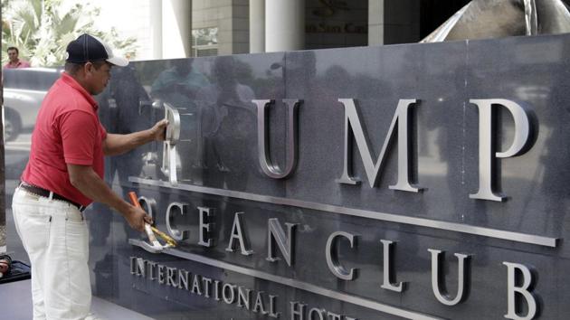 A worker removes the Trump sign letters from outside the hotel in Panama City on March 5, 2018. (AFP Photo) A worker removes the Trump sign letters from outside the hotel in Panama City on March 5, 2018. (AFP Photo)