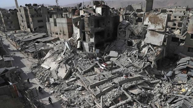 A general view shows several destroyed buildings in Douma, in the rebel enclave of Eastern Ghouta on the outskirts of Damascus on March 5, 2018. An international convoy entered Syria's rebel enclave of Eastern Ghouta to deliver much-needed aid today as the regime pounded the region with fresh bombardment, killing dozens as it seized more ground. (AFP) A general view shows several destroyed buildings in Douma, in the rebel enclave of Eastern Ghouta on the outskirts of Damascus on March 5, 2018. An international convoy entered Syria's rebel enclave of Eastern Ghouta to deliver much-needed aid today as the regime pounded the region with fresh bombardment, killing dozens as it seized more ground. (AFP)