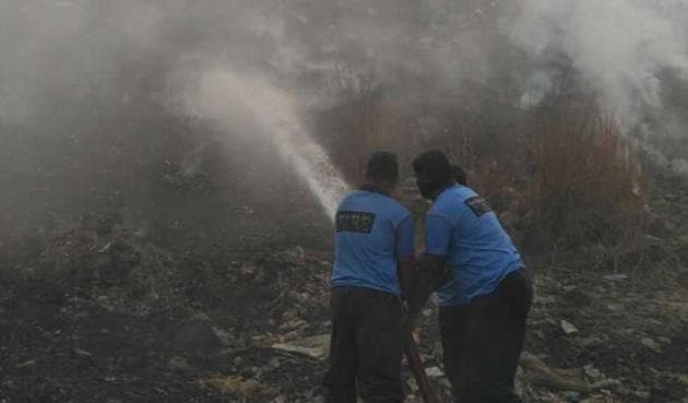The dumping ground continued to release thick smoke on Wednesday morning, more than 12 hours after the fire started. (HT Photo) The dumping ground continued to release thick smoke on Wednesday morning, more than 12 hours after the fire started. (HT Photo)