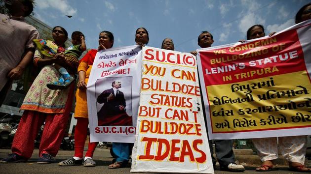 Activists of Socialist Unity Centre of India (SUCI) hold placards and shout anti-government slogans during a protest against what they say was the demolition of a statue of Vladimir Lenin in Tripura. (Reuters Photo)