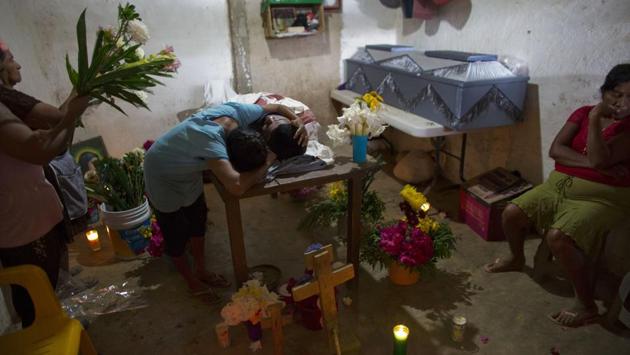 Maribel Julio Meneses weeps over the body of her son Daniel Julio Julio, a 22-year-old member of one militia, killed on duty in an ambush. Organised crime groups have tried to co-opt and divide them, resulting in instances in which the local ‘citizen police’ have opened fire on each other as well. (Rebecca Blackwell / AP)