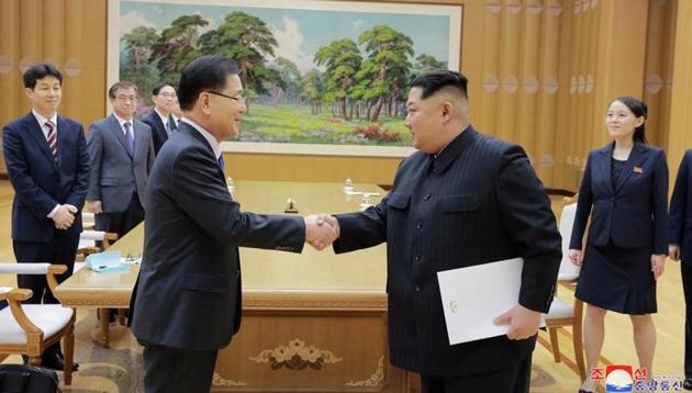 North Korean leader Kim Jong Un shakes hands with a member of the special delegation of South Korea's President(KCNA/via Reuters)