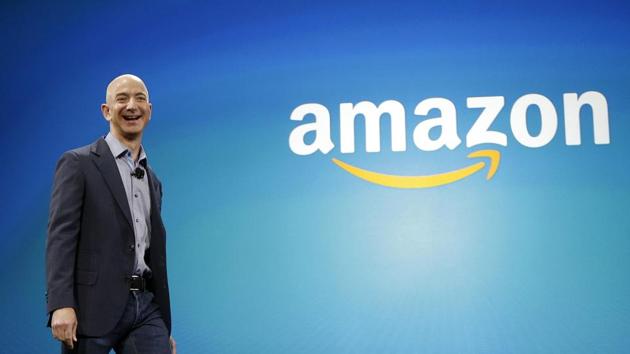 In this June 16, 2014, file photo, Amazon CEO Jeff Bezos walks onstage for the launch of the new Amazon Fire Phone, in Seattle. Bezos has become the first person to amass a fortune surpassing $100 billion in Forbes magazine’s annual ranking of the world’s moguls. (AP Photo) In this June 16, 2014, file photo, Amazon CEO Jeff Bezos walks onstage for the launch of the new Amazon Fire Phone, in Seattle. Bezos has become the first person to amass a fortune surpassing $100 billion in Forbes magazine’s annual ranking of the world’s moguls. (AP Photo)