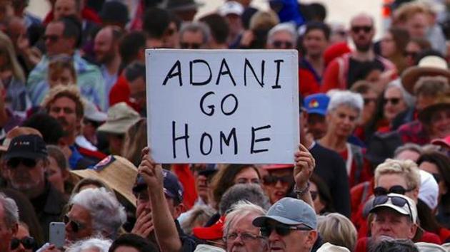 A protester holds a sign as he participates in a national Day of Action against Adani's planned coal mine project in north-east Australia, at Sydney's Bondi Beach in Australia. (Reuters File Photo) A protester holds a sign as he participates in a national Day of Action against Adani's planned coal mine project in north-east Australia, at Sydney's Bondi Beach in Australia. (Reuters File Photo)