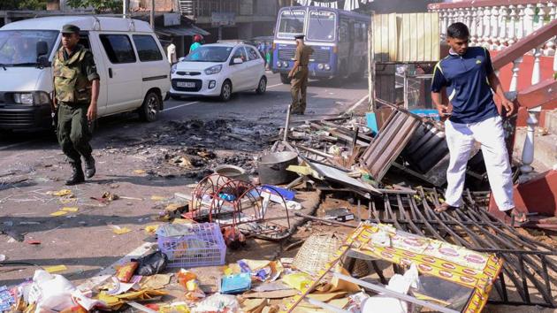 Sri Lankan police commandos patrol next to debris from a damaged shop in Kandy. Tensions erupted after a Sinhalese truck driver was killed on Saturday by a group of Muslim men in what has been described as a road rage incident. Following that, Buddhist mobs swept through the hill town of Kandy on Monday, burning at least 11 Muslim-owned shops and homes. (AFP) Sri Lankan police commandos patrol next to debris from a damaged shop in Kandy. Tensions erupted after a Sinhalese truck driver was killed on Saturday by a group of Muslim men in what has been described as a road rage incident. Following that, Buddhist mobs swept through the hill town of Kandy on Monday, burning at least 11 Muslim-owned shops and homes. (AFP)
