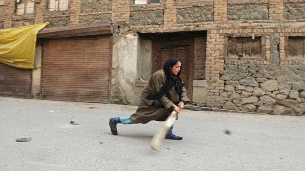 A Kashmiri girl plays cricket on a street during restriction in downtown area of Srinagar. Authorities on Wednesday imposed restrictions in parts of Srinagar and Shopian district to maintain law and order in view of a strike and a protest march called by separatists against shifting of Kashmiri prisoners out of the Valley and killings in a firing incident on Sunday. (Waseem Andrabi / HT Photo) A Kashmiri girl plays cricket on a street during restriction in downtown area of Srinagar. Authorities on Wednesday imposed restrictions in parts of Srinagar and Shopian district to maintain law and order in view of a strike and a protest march called by separatists against shifting of Kashmiri prisoners out of the Valley and killings in a firing incident on Sunday. (Waseem Andrabi / HT Photo)
