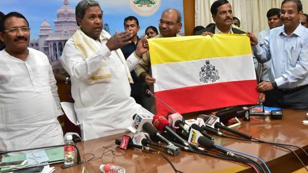 The Siddaramaiah-led Karnataka government unveiled a state flag on Thursday.The flag design will now be sent to the Central Government for approval, following which it will be announced as the state flag. The unveiled flag consists of three colors- red, white and yellow and has state emblem “Ganda Bherunda”, a two-headed mythical bird in the middle. (ANI)