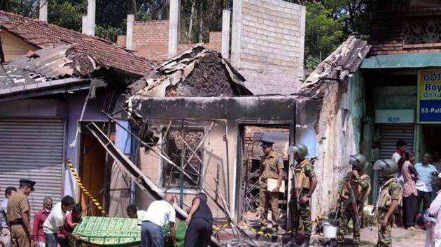 Sri Lanka's Special Task Force and police officers stand guard near a burnt house after a clash between two communities in Digana, Kandy, Sri Lanka, March 6, 2018 (Reuters) Sri Lanka's Special Task Force and police officers stand guard near a burnt house after a clash between two communities in Digana, Kandy, Sri Lanka, March 6, 2018 (Reuters)